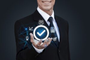 Professional insurance agent in a suit holding a digital checkmark icon representing verified ACA live transfer leads and business success.